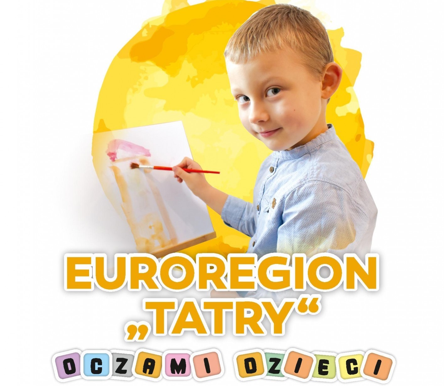 Plakat - euroregion tatry oczami dzieci. Mały chłopiec maluje farbami rysunek.