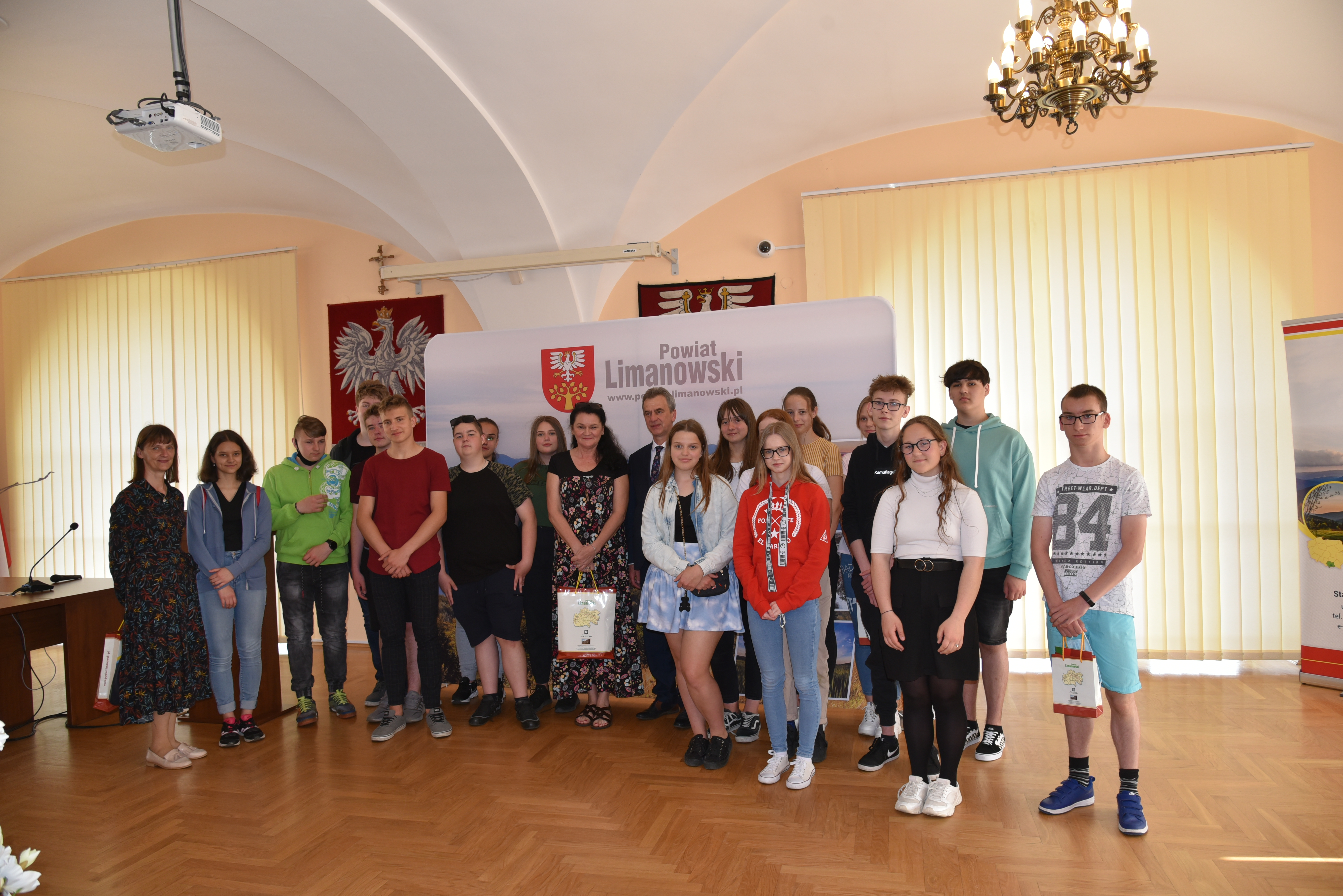 Zdjęcie grupowe uczniów ze Starostą Limanowskim Mieczysławem Urygą na sali konferencyjnej