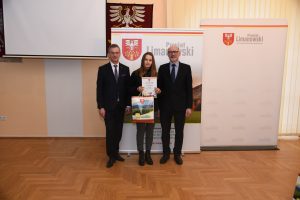 starosta i Wojciech Włodarczyk z nagrodzoną dziewczyną która trzyma dyplom i upominek