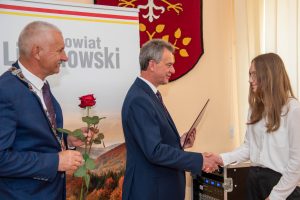 starosta wręcza nagrodę Ewie Murzyn , obok przewodniczący rady z różą