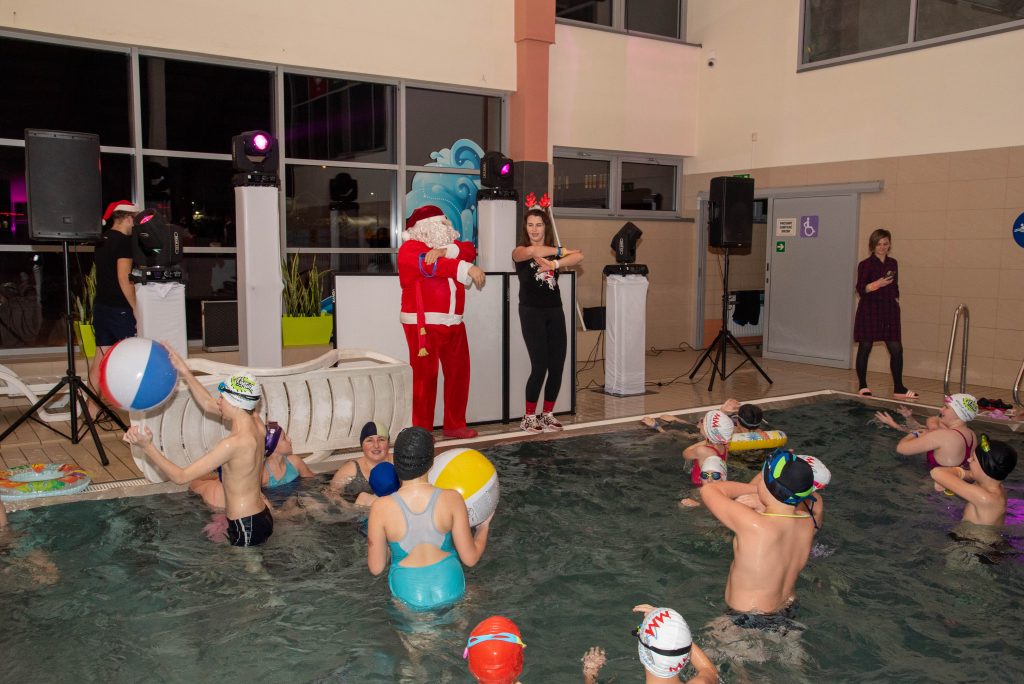 Mikołaj, animatorka i dzieci tańczące w basenie